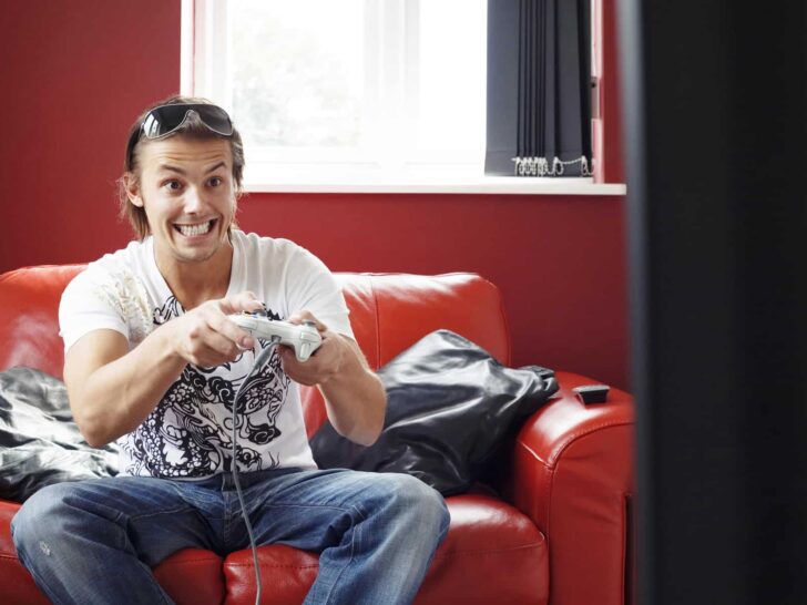 man sitting on the couch ready to earn money playing games