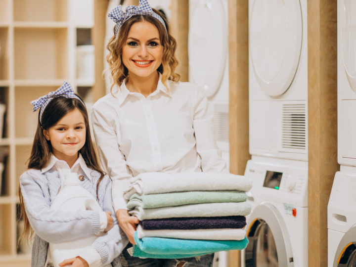 mother and daughter doing laundromat business self service